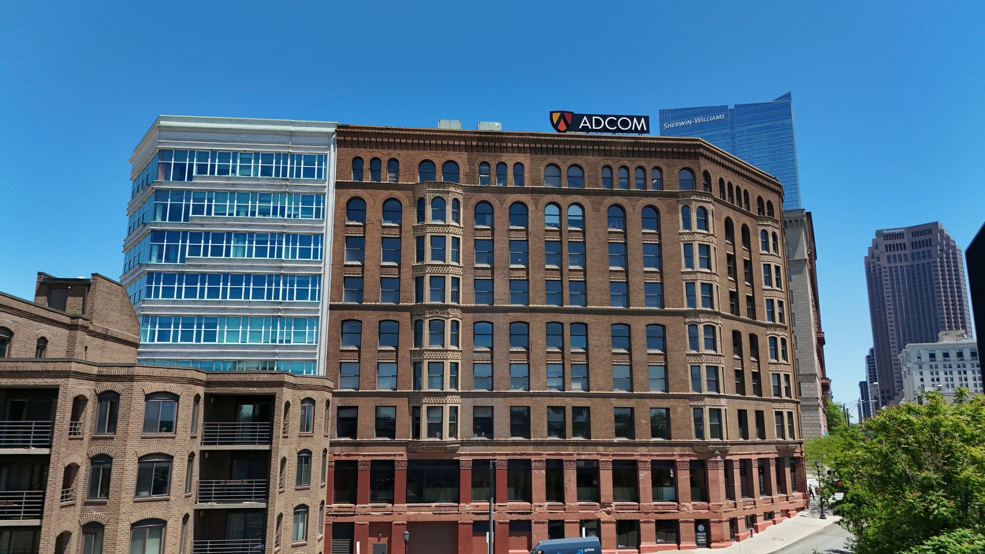 Aerial detail of a historic brick commercial building in downtown Cleveland with modern towers behind — Stratum Aerial Media